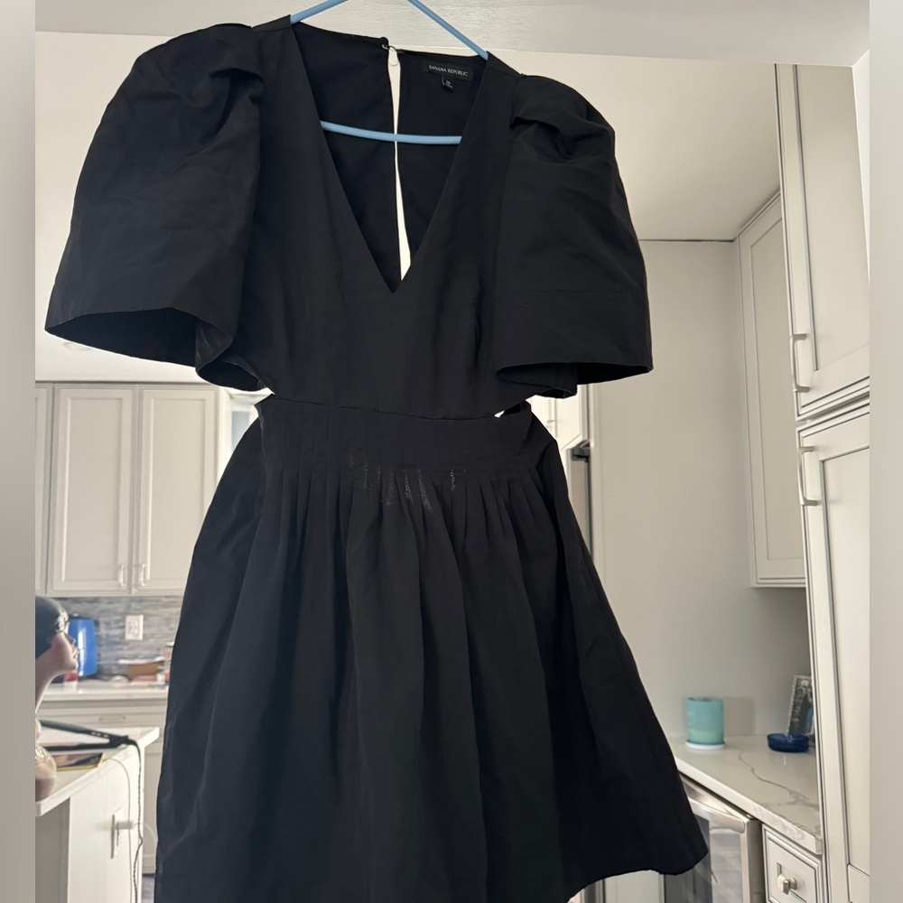 Little black open back with pockets and side cutouts cocktail dress.